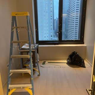 Freshly painted Manhattan apartment room with the skyline through the window