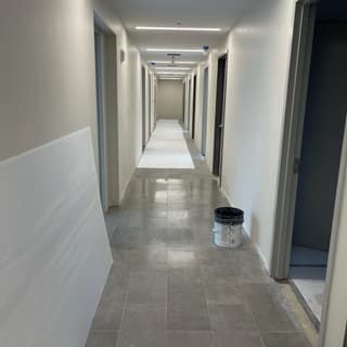 Finished commercial corridor with painted walls, recessed lighting, and tiled floor